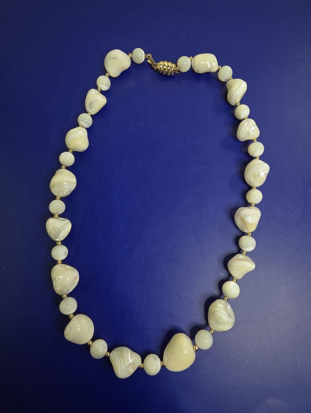 Elegant Cream Swirl Bead Necklace with Gold Accents